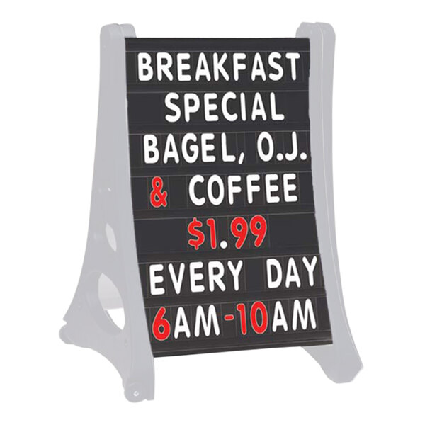 A black curved letterboard sign with white letters on a counter.