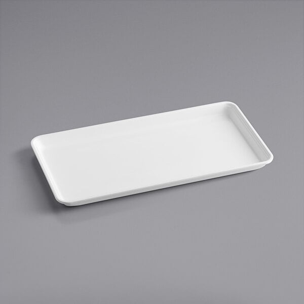 A white rectangular MFG Tray on a gray surface.