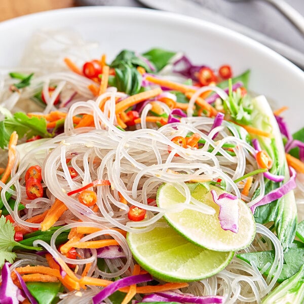 A bowl of sweet potato noodles with vegetables.
