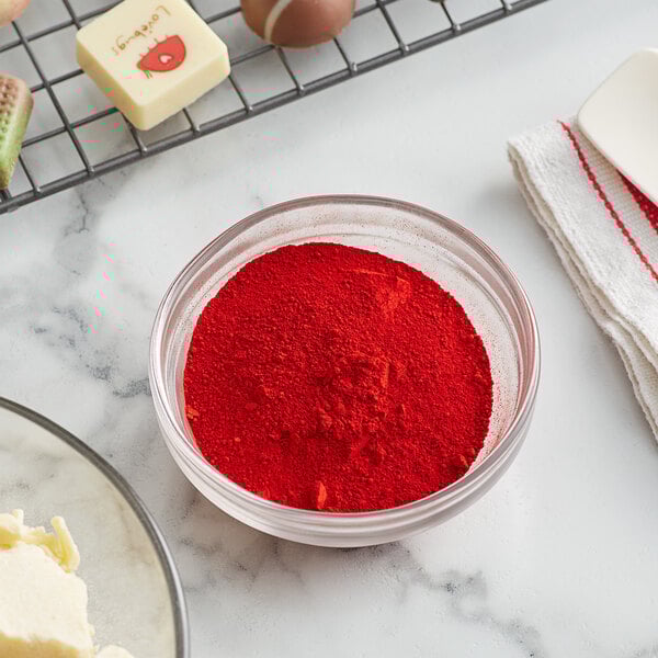 A bowl of Roxy & Rich Red fat dispersible powder next to a bowl of butter.