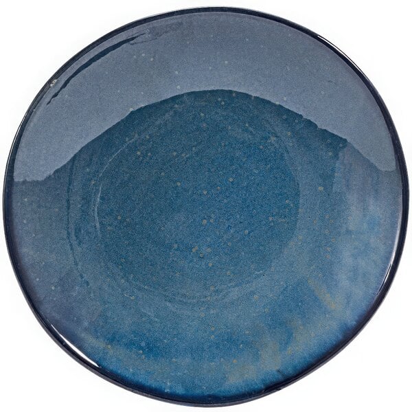 An indigo porcelain low bowl with a speckled surface.