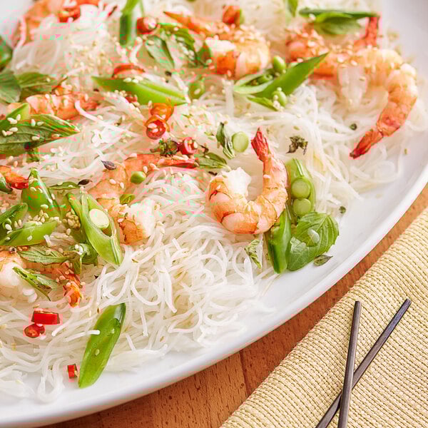 A plate of Excellent Bihon noodles with shrimp and vegetables.