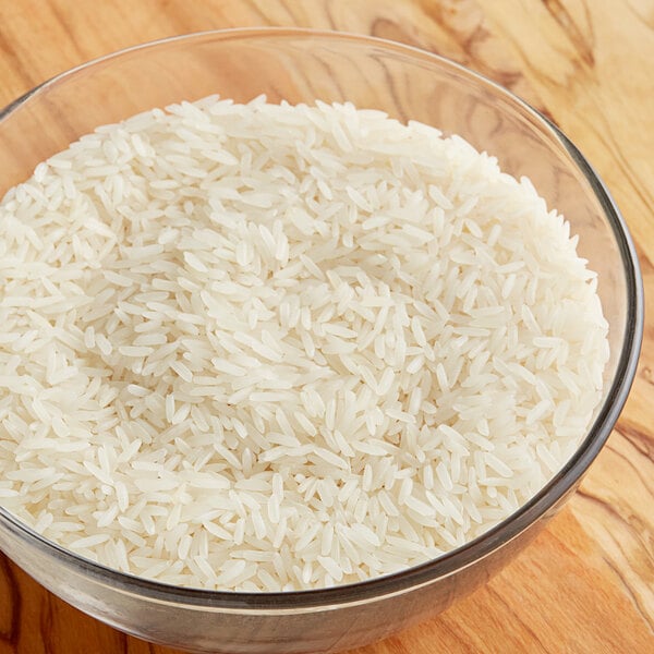 A bowl of Gold Thai Jasmine Rice on a wood surface.