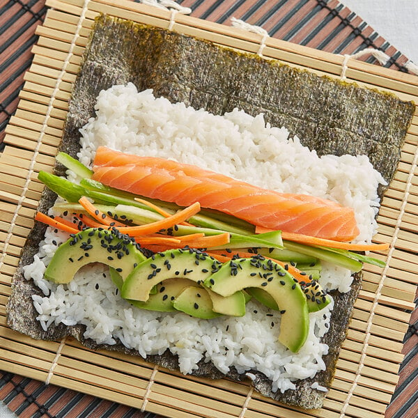 Sushi ingredients on a bamboo rolling mat