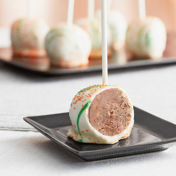 Individually wrapped Chalet Desserts carrot cake pop on a white background.
