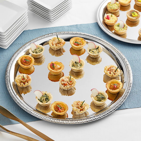 An American Metalcraft stainless steel serving tray with appetizers on it.