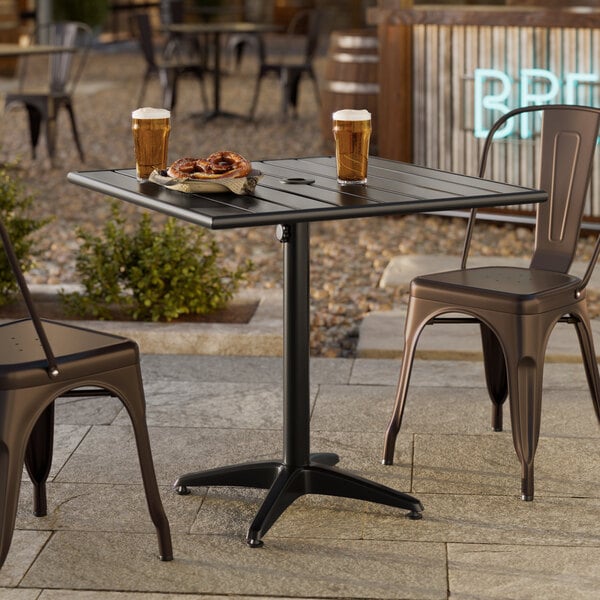 A black powder-coated aluminum outdoor dining table with an umbrella hole, measuring 32 inches by 32 inches.