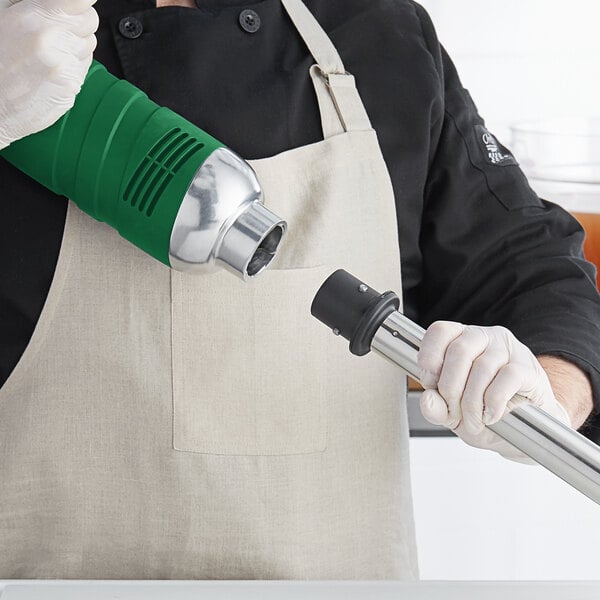 A man using an AvaMix medium-duty variable speed immersion blender to mix.