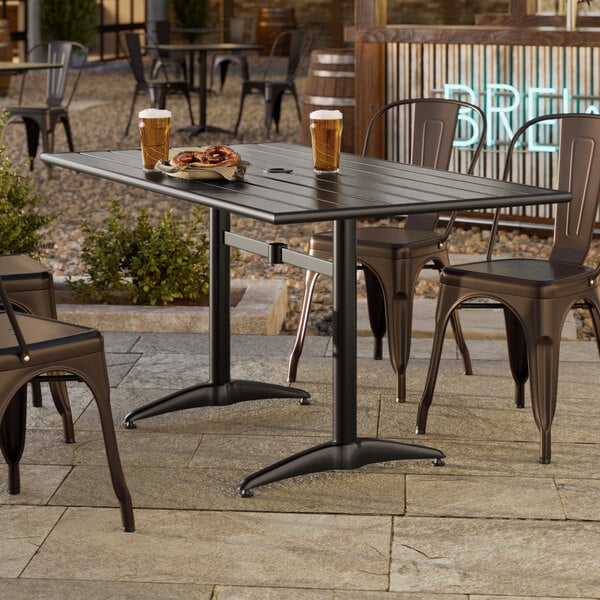 A rectangular black powder-coated aluminum outdoor dining table with an umbrella hole.