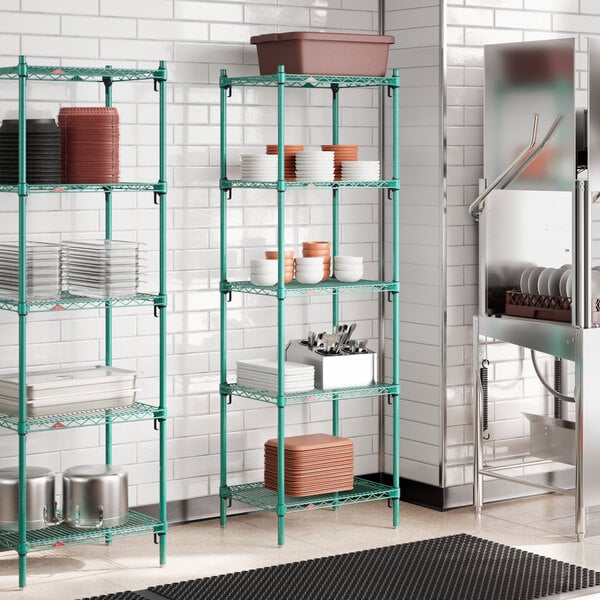 A green stationary wire shelving unit with multiple adjustable shelves, used for kitchen storage.