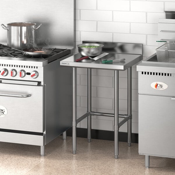 A Regency stainless steel open base work table in a professional kitchen.