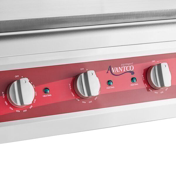 A white Avantco countertop electric griddle with red knobs.