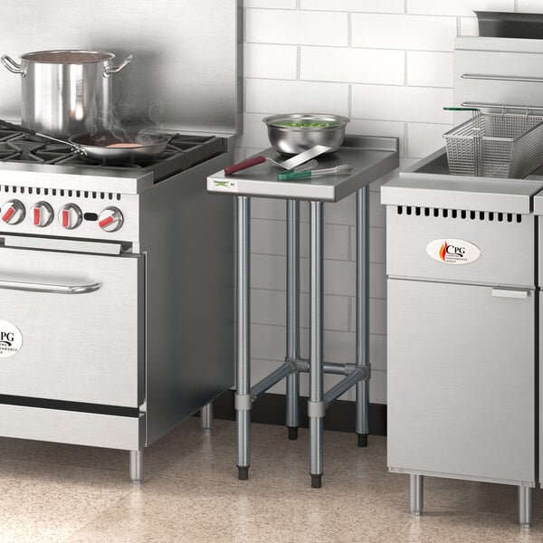 A Regency stainless steel filler table with pots on a counter in a professional kitchen.