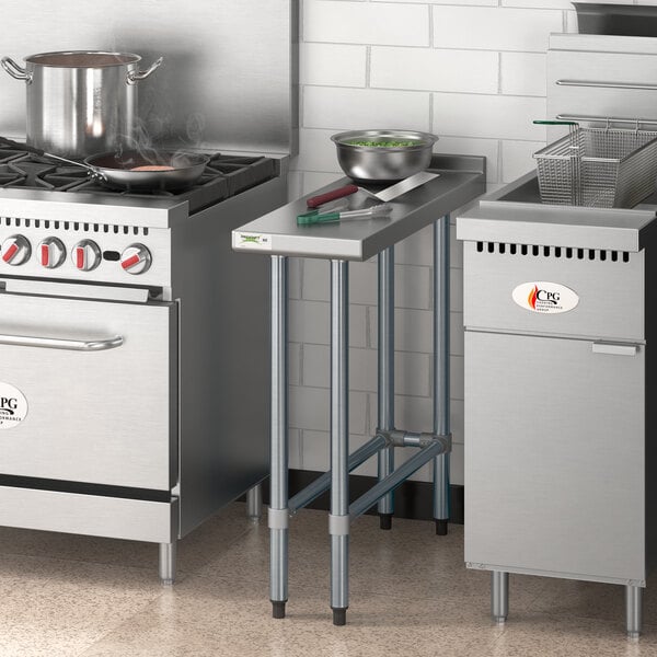 A Regency stainless steel filler table on a counter in a professional kitchen.