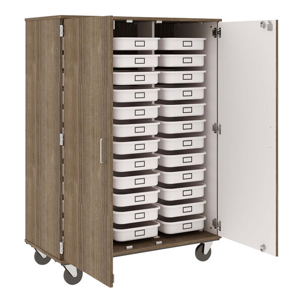 An I.D. Systems mobile storage cabinet with white doors and many white bins on wheels.