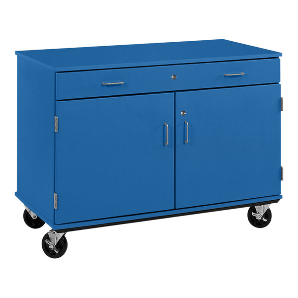 A royal blue cabinet on wheels with two doors and a drawer.