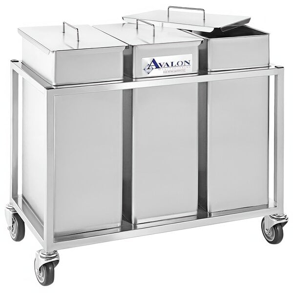 A white rectangular metal container with three silver bins on wheels.