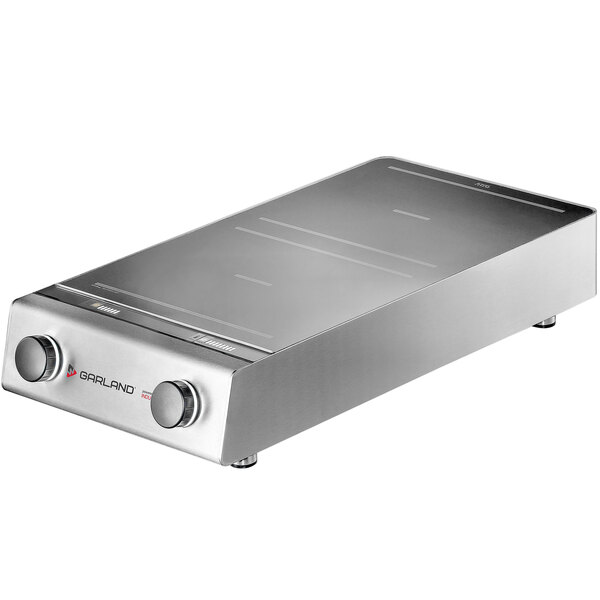 A silver rectangular Garland Instinct countertop range with knobs.
