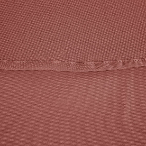A close up of a mauve round cloth table cover with a hemmed edge.