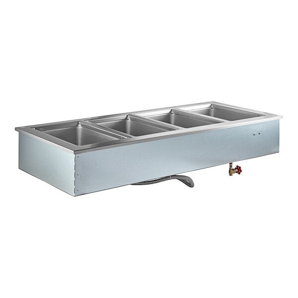 A Delfield stainless steel drop-in hot food well holding four food pans.