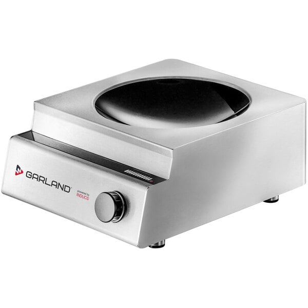 A silver Garland countertop induction wok range with a black circle on top.