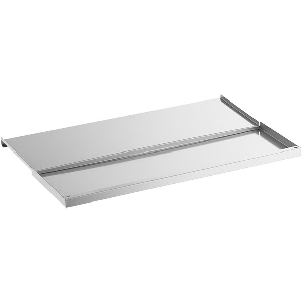 A stainless steel lid with a sliding mechanism on a white rectangular tray.