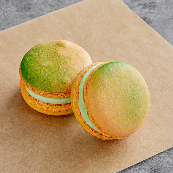 a close up of a green and yellow macaroon