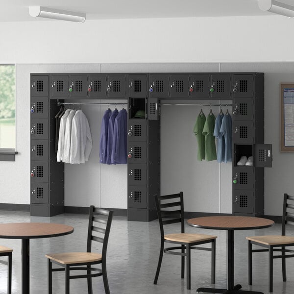 A room with a Regency black 6 tier locker and tables and chairs.