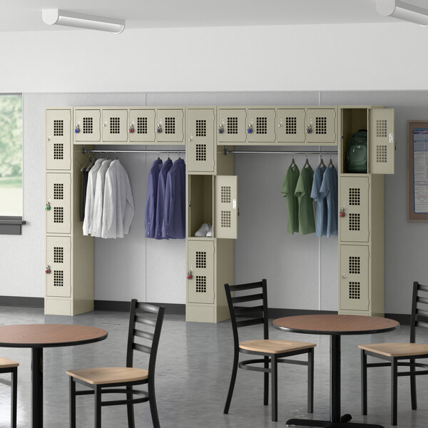 A Regency beige 3 tier locker with garment rack and several compartments.