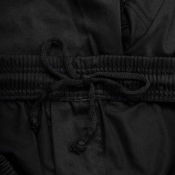 A close up of black Chef Revival cargo pants with a drawstring.