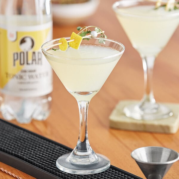 A glass of Polar Diet Tonic Water with a lemon garnish on a table.