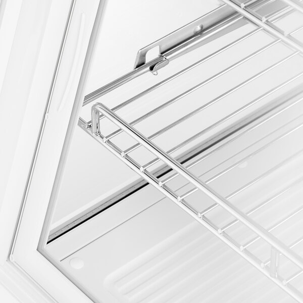 A white Avantco countertop refrigerator with a metal shelf.