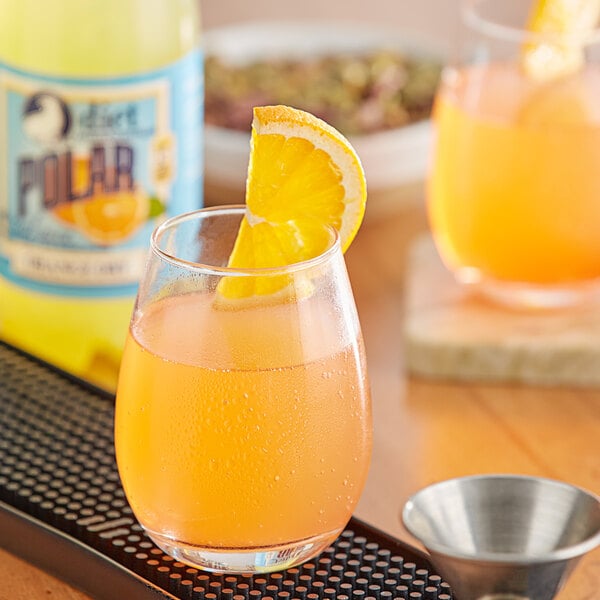 A glass of Polar Diet Orange juice with a slice of orange on top.