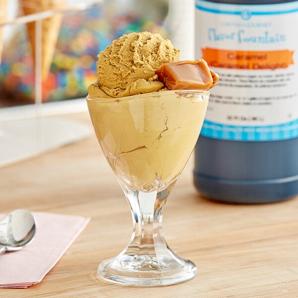 A glass of ice cream with LorAnn Caramel Flavor Fountain syrup on a counter.