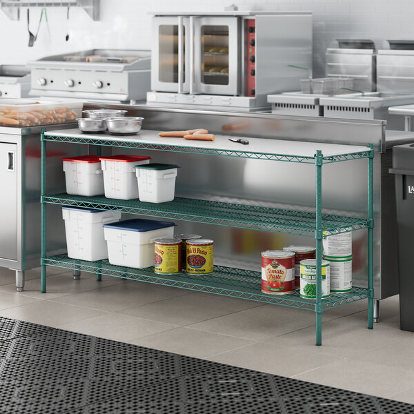 A Regency green metal shelving unit in a kitchen with food on the shelves.