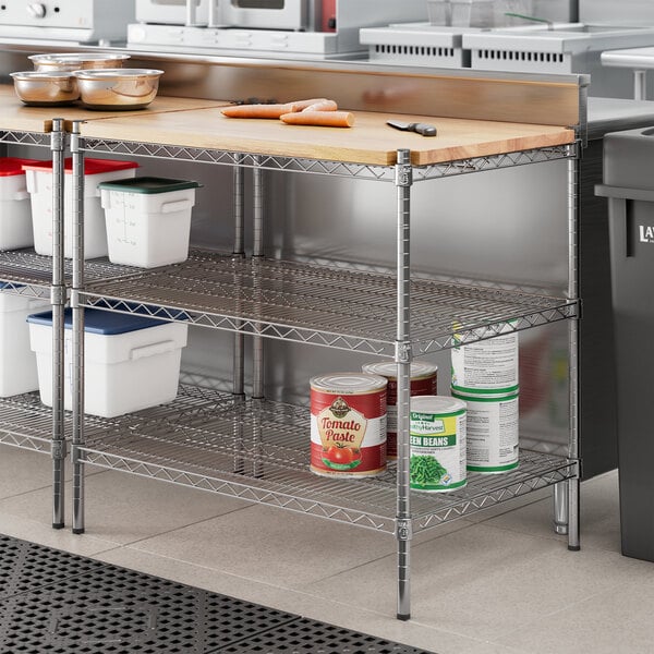 A Regency metal shelf with a wooden top on a stainless steel counter.