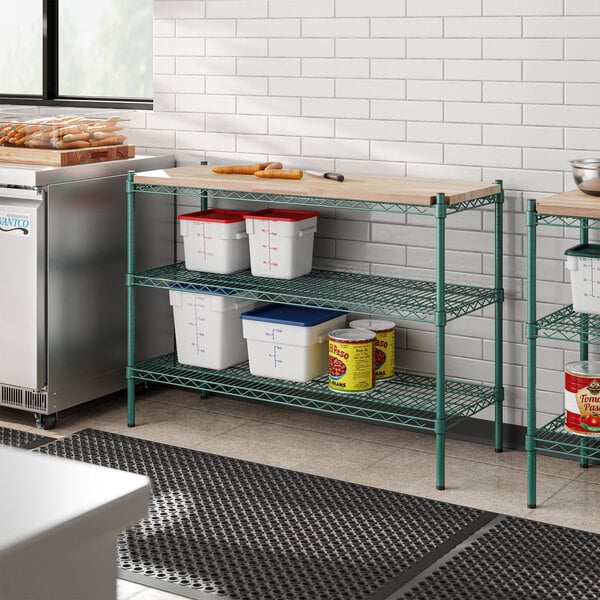 A school kitchen with a Regency green epoxy shelving unit on a counter.