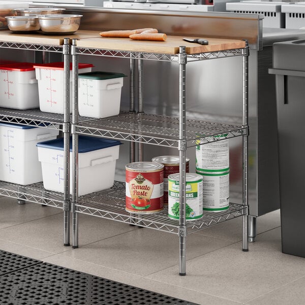 Regency chrome metal shelving with wooden shelves holding food containers.