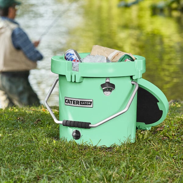 A seafoam green CaterGator outdoor cooler with a handle.