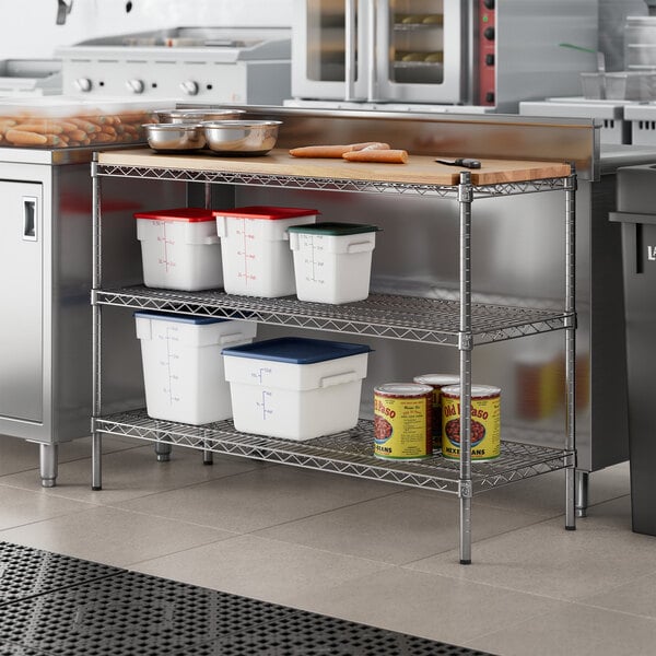 A Regency stainless steel kitchen shelf with a wooden insert on a metal shelf with food containers.