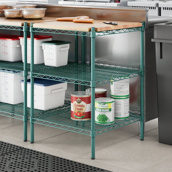 Regency green epoxy shelving with wooden shelves holding food containers.