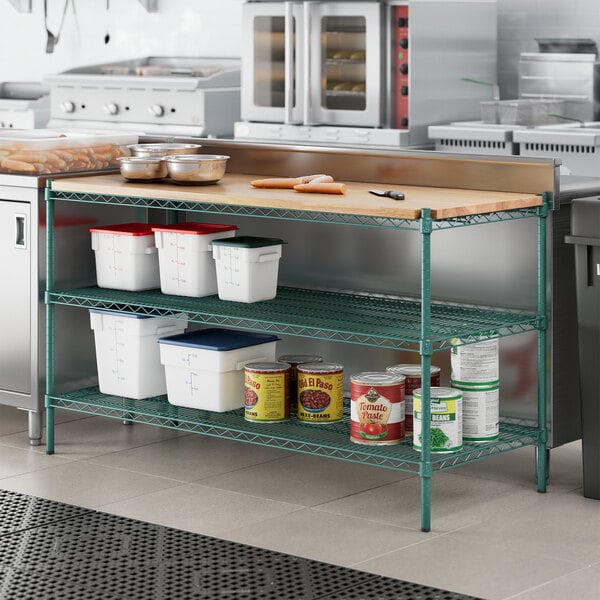 A kitchen with a wooden cutting board shelf insert on green Regency shelves.