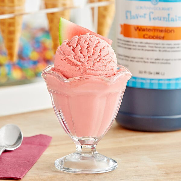 A glass cup of pink ice cream with LorAnn Watermelon Cooler syrup on top.