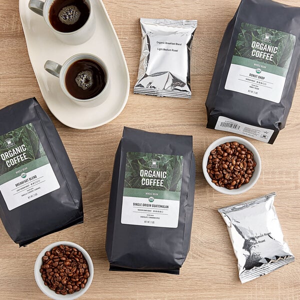 A table with bags of Crown Beverages Organic Single Origin Colombian Coffee and coffee beans.