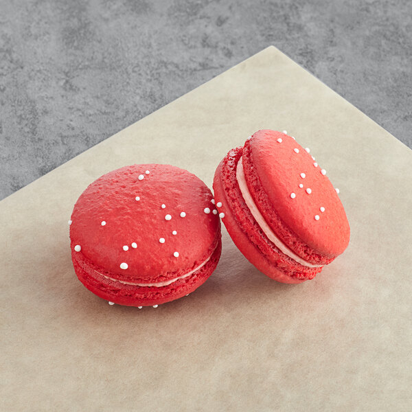 two red cookies with white sprinkles