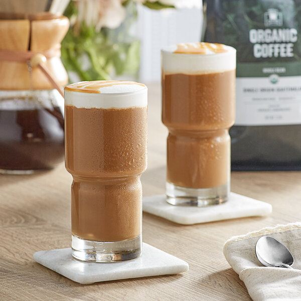 Two glasses of Crown Beverages Guatemalan coffee on a table.