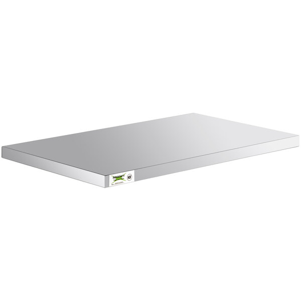 A white rectangular stainless steel shelf for Regency enclosed base tables with a green sticker.