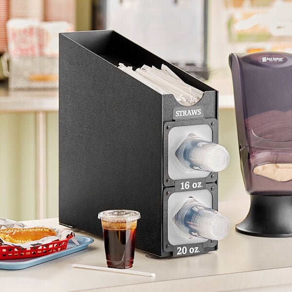 A black KleanTake countertop cup dispenser with a straw organizer on top.