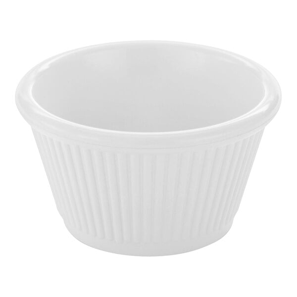 A small, white, fluted bowl with a smooth interior and ribbed exterior.