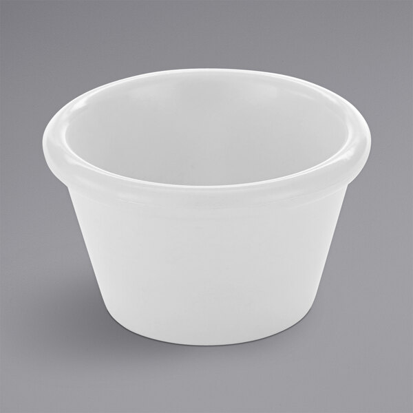 An American Metalcraft white melamine ramekin on a gray surface.